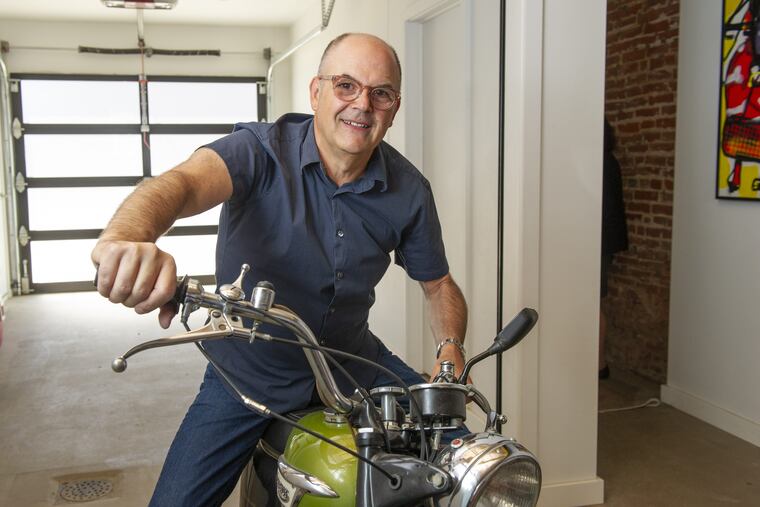 Harry Simmons wanted a new home — and a place to display his prized 1970 Triumph Motorcycle. The rear of the garage opens into the entryway and patio.