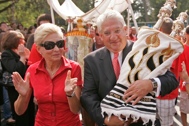 Leonard Barrack and his wife, Lynne , carry an Ashkenazi torah to the Bryn Mawr school named for his brother, Jack M. Barrack.