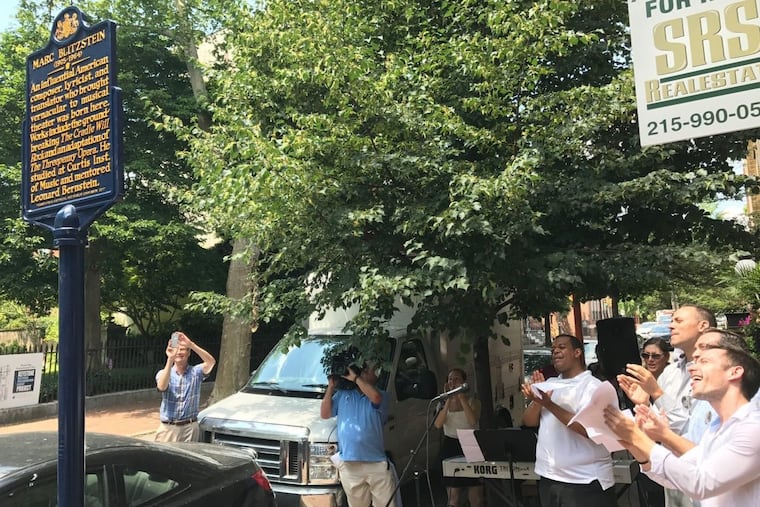 Singers cheer the unveiling of a historical marker noting the birthplace of composer Marc Blitzstein at 419 Pine St.