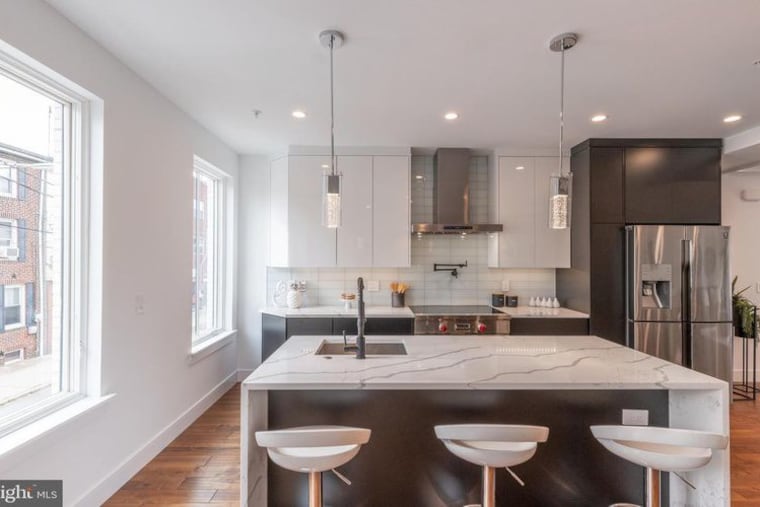 The kitchen features a Carrara marble island.
