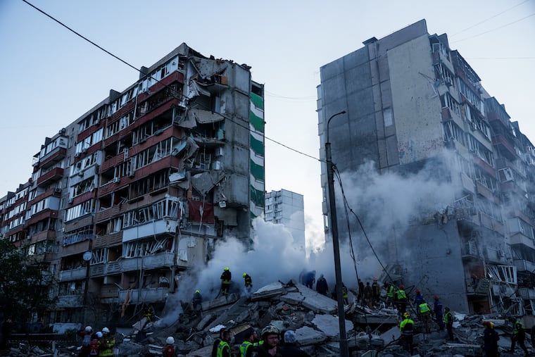 Rescue workers clear the rubble of a building heavily damaged after a Russian strike on a residential neighborhood in Kyiv, Ukraine, on Thursday, May 14, 2026.