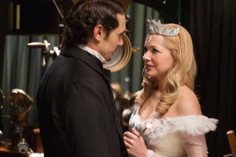 This film image released by Disney Enterprises shows James Franco, left, and Michelle Williams in a scene from "Oz the Great and Powerful." (AP Photo/Disney Enterprises, Merie Weismiller Wallace)