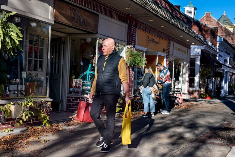 A shopper passes Sole Active on Kings Highway in downtown Haddonfield on Saturday, Nov. 18, 2023, as small businesses prepared for the holiday season ahead of Small Business Saturday.