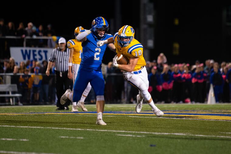 Downingtown East's Spencer Uggala (10), shown here against Downingtown West, rushed for 106 yards against Coatesville on Friday.