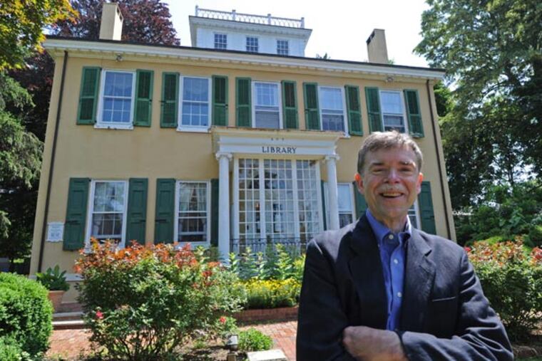 The Mount Holly Public Library, which just celebrated its 250th anniversary. Here, library director Michael Eck with a Revolutionary War cannonball found in a residents yard from the Battle of Ironworks Hill and an encyclopedia of plants circa 1640.