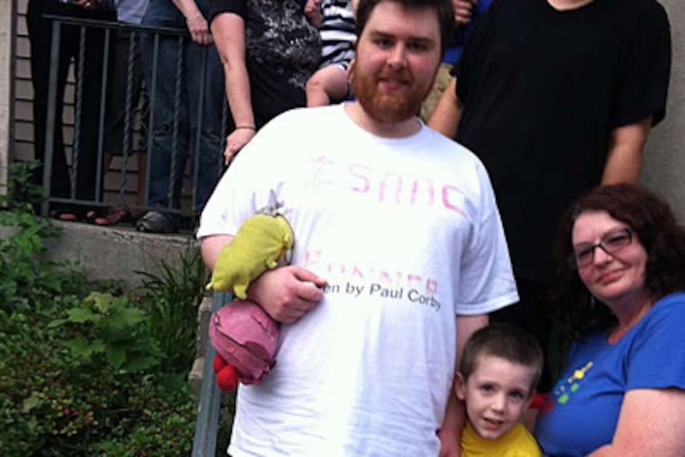 Paul Corby, 23, (left) with family, was rejected for a heart transplant. His mother, Karen Corby (right), is protesting.