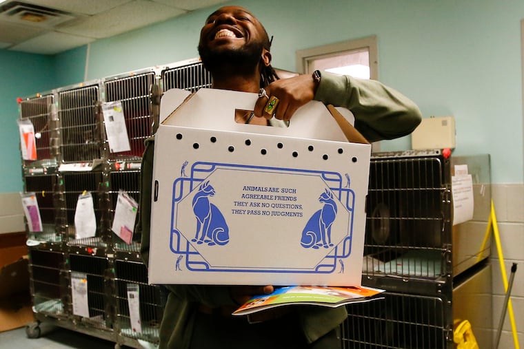 Joshua Dufour smiles as he takes home his his adopted cat from the ACCT shelter in North Philly.