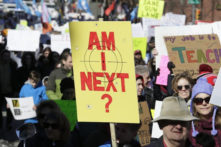 Marchers walk down Market Street in Philadelphia.