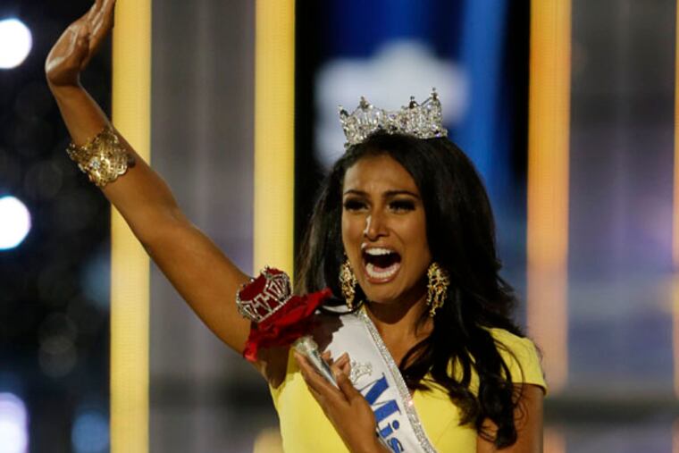 Miss New York Nina Davuluri walks down the runway after winning the the Miss America 2014 pageant, Sunday, Sept. 15, 2013, in Atlantic City, N.J. (AP Photo/Mel Evans)