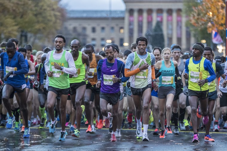 The elite runners take off down the Benjamin Franklin Parkway at the start of the the Philadelphia Marathon last year.