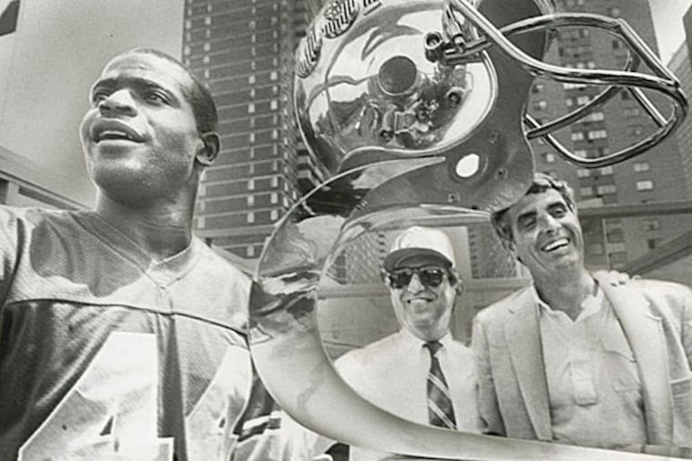 Player Kelvin Bryant (left), owner Myles Tanenbaum (center) and coach Jim Mora celebrated the Stars' USFL championship on July 16, 1984.