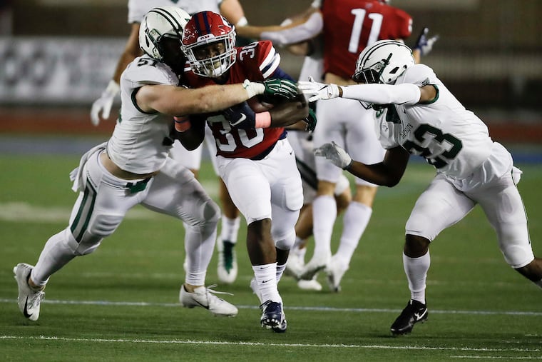 Penn running back Karekin Brooks runs with the football against Dartmouth linebacker Jack Traynor (left) and Dartmouth cornerback Darren Stanley (right) during the first-quarter on Friday, October 4, 2019 in Philadelphia