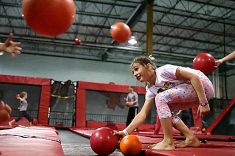 Kids play a game at Xtreme Trampolines in Carol Stream, Ill. Parks have spread from the West Coast to the Midwest. (STACEY WESCOTT/Chicago Tribune)