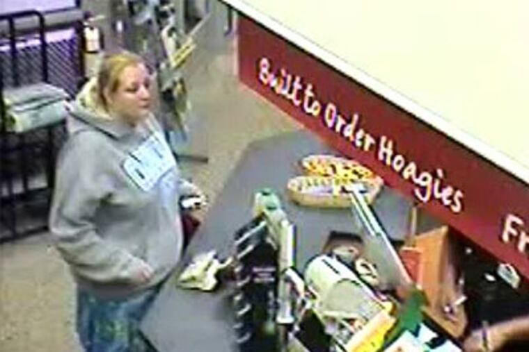 Surveillance video shows a female suspect who attempted to use a credit card owned by a robbery victim. (Photo from West Chester police)
