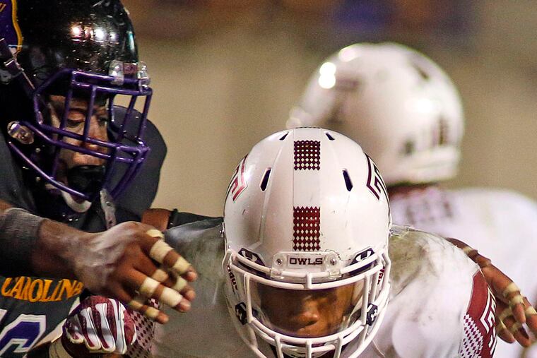 Temple running back Jahad Thomas breaks away from East Carolina's Demetri McGill in the Owls' 24-14 comeback victory.