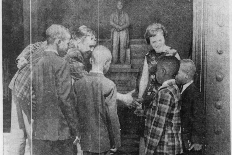 The first Black boys admitted to Girard College are greeted at Founder's Hall by James Duff, school psychologist, and Mrs. Louise Gemmell, assistant director of admissions. The youngsters are (from left) William L. Dade, 11; Carl W. Riley, 8; Owen Gowans, 7, and Theodore L. Hicks, 9.