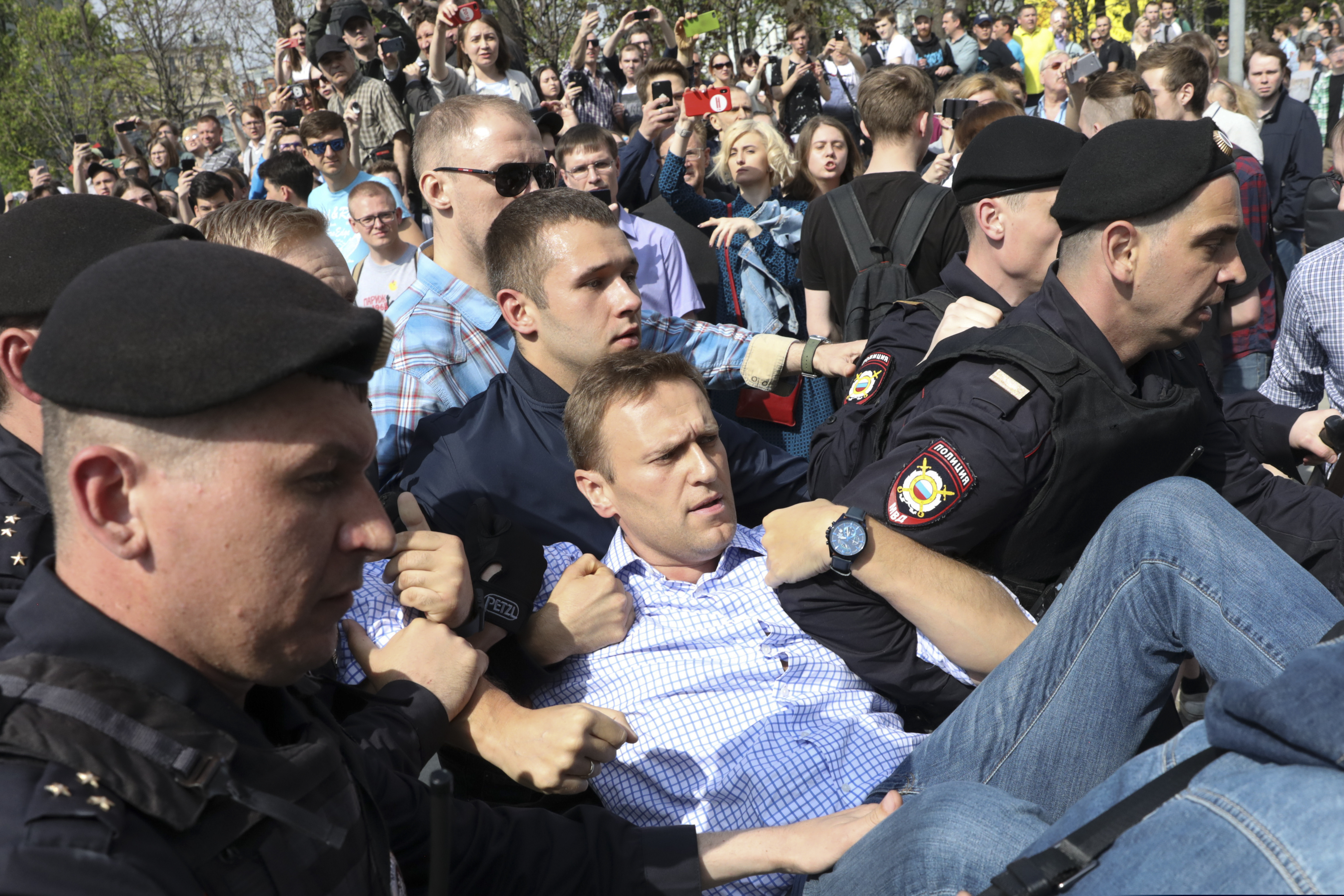 Russian police carrying opposition leader Alexei Navalny (center) from a demonstration against President Vladimir Putin in Pushkin Square in Moscow on May 5, 2018.