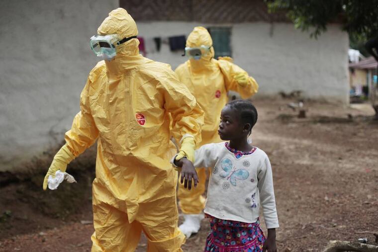 FILE - In this Tuesday, Sept. 30, 2014 file photo, Nowa Paye, 9, is taken to an ambulance after showing signs of Ebola infection in the village of Freeman Reserve, about 30 miles north of Monrovia, in Liberia. In a delay that some say may have cost lives, the World Health Organization resisted calling the Ebola outbreak in West Africa a public health emergency until the summer of 2014, two months after staff raised the possibility and long after a senior manager called for a drastic change in strategy, The Associated Press has learned. (AP Photo/Jerome Delay, File)