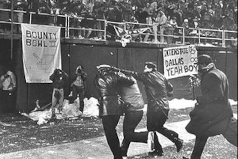 n 1989, police escorting Dallas head coach (and snowball target) Jimmy Johnson to safety.