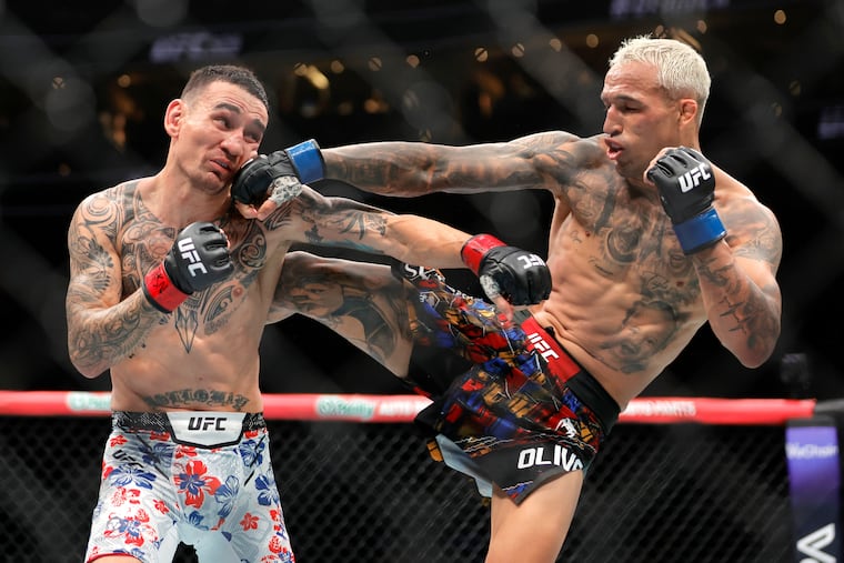 Charles Oliveira, right, punches Max Holloway in a UFC fight in Las Vegas. The White House is planning to host six UFC caged matches on the South Lawn on President Donald Trump's birthday.