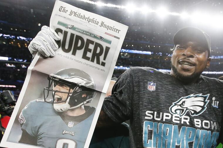 Eagles outside linebacker Nigel Bradham holding the Inquirer after the Eagles beat the New England Patriots in Super Bowl LII.
