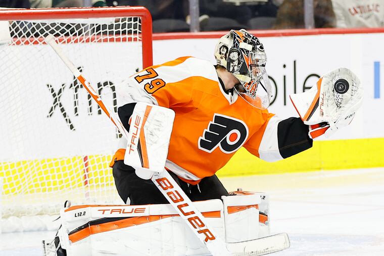 Flyers goaltender Carter Hart catches the puck during the second period against the Minnesota Wild.