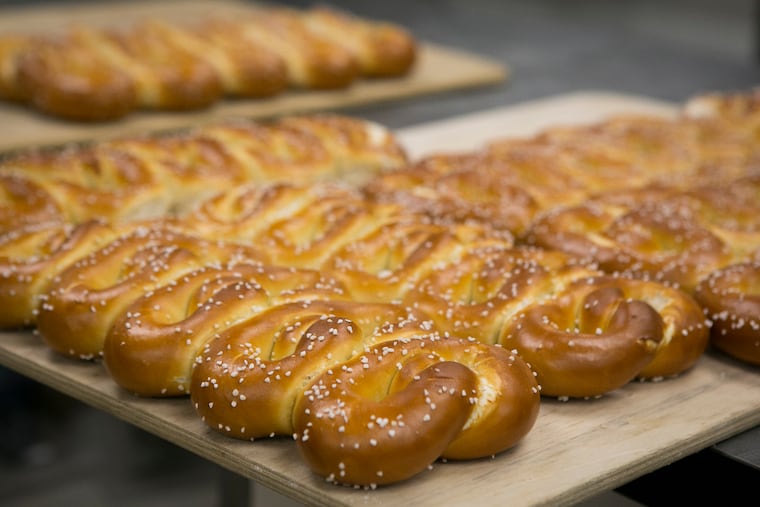 Freshly baked "penny pretzels" cool in the test kitchen at Philly Pretzel Factory headquarters in Bensalem, Pa., on the morning of Thursday, August 9, 2018.