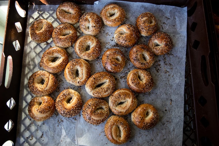 Brett Frankel, co-founder of Bart’s Bagels, pulls bagels out of the oven and empties them into a tray on Wednesday, Jan. 22, 2020. The West Philly-born bagel shop is opening its third location in Bala Cynwyd later this year.