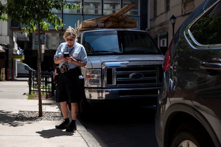 A PPA enforcement officer tickets a truck on Filbert Street in June 2022.