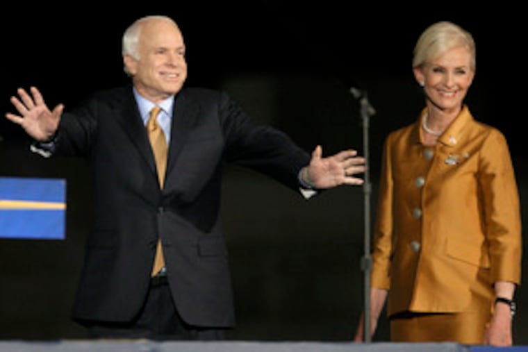Sen. John McCain is joined on stage by his wife, Cindy, during the election-night rally in Phoenix. At one point, organizers temporarily stopped displaying the returns so as not to put a damper on the party.