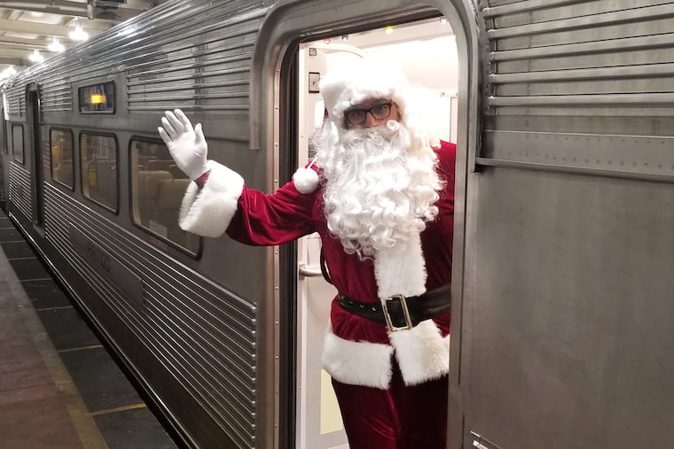 Santa Claus waves from the door of a PATCO train during the commuter railroad's annual 'Silver Sleigh' event for children. Specially decorated PATCO trains made several trips along the line between Lindenwold, N.J. and Center City Philadelphia.