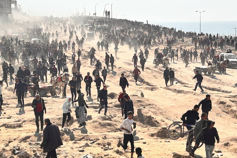 Palestinians wait for humanitarian aid on a beachfront in Gaza City on Feb. 25. The U.S. should press for a new U.N. Security Council resolution to get food, fuel, water, medicine, and shelter into Gaza, writes Trudy Rubin.