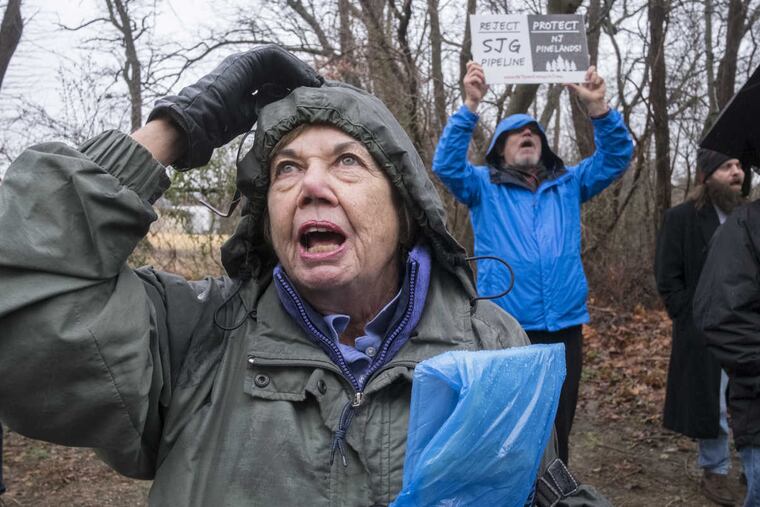 The Pinelands Commission holds a public comment session Tuesday on South Jersey Gas' controversial application to run a pipeline through 10 miles of protected pinelands forest. Even though the session was relocated to a Catholic Church to accommodate anticipated crowds many people were denied access because officials said the meeting room had filled to capacity. Here, Lynne O'Carroll of Somerset, N.J., joined protesters chanting "Stop the Pipeline" outside the meeting. Behind O'Carroll is Don Cramer from Glassboro.