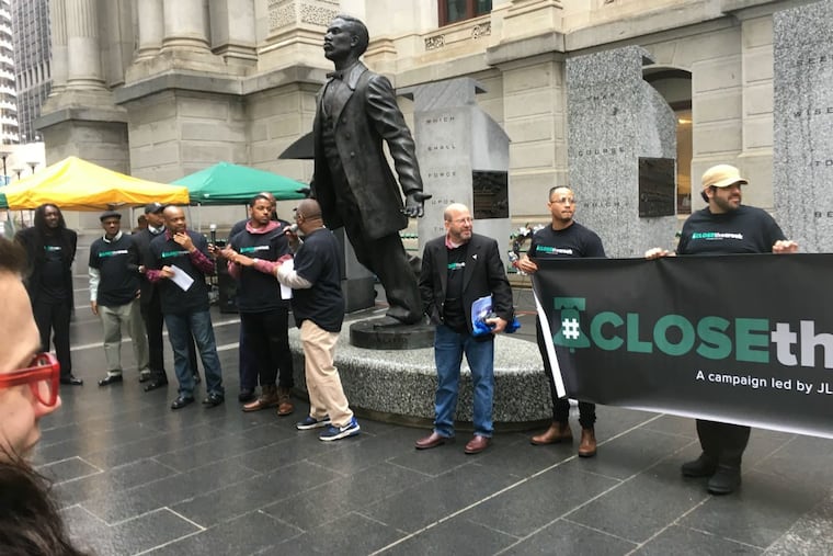 Prison reform activists protest outside Philadelphia City Hall April 25, 2018, calling for demolition of the House of Correction.