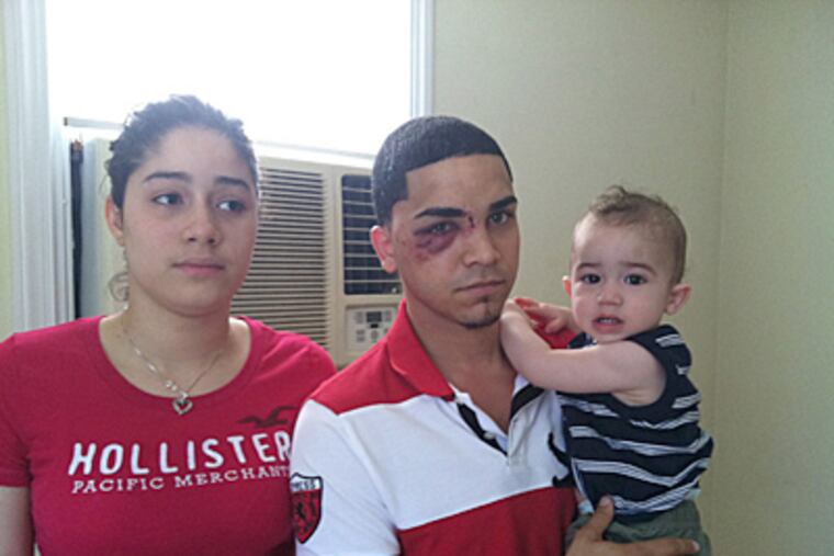 From left, Kissayris Salcedo, 21, her husband, Joesmir Caceres, 21, and their 11-month-old son, Joe Gabriel Caceres, stand in their house on Friendship Street near Frontenac in the Castor Gardens section of the city on Sunday, June 10, 2012, hours after three men invaded their home about 3 a.m. the same day and robbed them of more than $10,000.