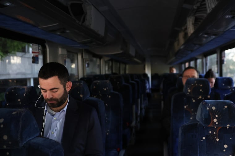 Commuters sit on a shuttle bus as Long Island Rail Road workers strike, Monday, May 18, 2026, in Mineola, N.Y.