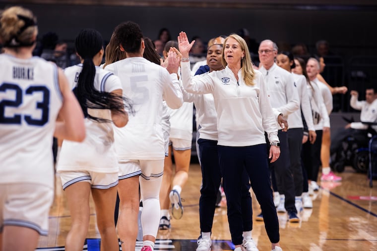 Coach Denise Dillon of Villanova high-fives the team before the WBIT quarterfinal against Portland on March 27.