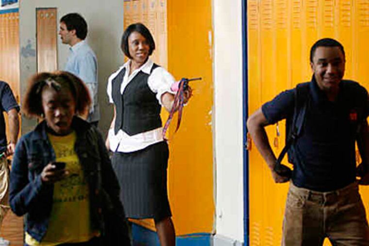 Principal Saliyah Cruz (center) keeps an eye on activity in a hallway during a classroom change. ( Michael S. Wirtz / Staff Photographer )