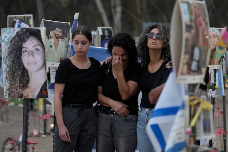 People react during a ceremony at the site of the Nova music festival, where hundreds of revelers were killed and abducted by Hamas and taken into Gaza, on the one-year anniversary of the attack, near Kibbutz Reim, southern Israel, on Monday.