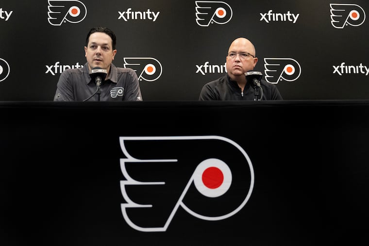 Flyers general manager Danny Briere (left) and assistant GM Brent Flahr discuss plans for the NHL draft. The team will have three first-round picks.