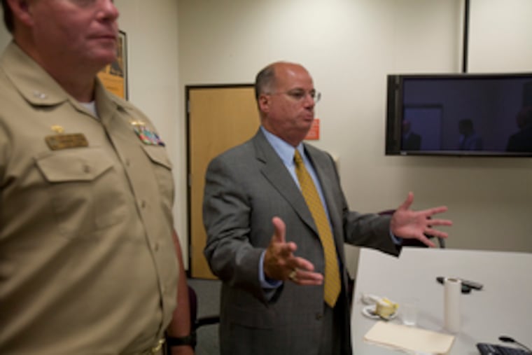 "Real sailors and Navy officers oversee the work so the Navy gets what it wants," says Lockheed executive Orlando Carvalho (right), here with Capt. Kris Biggs, the Navy's tech rep.