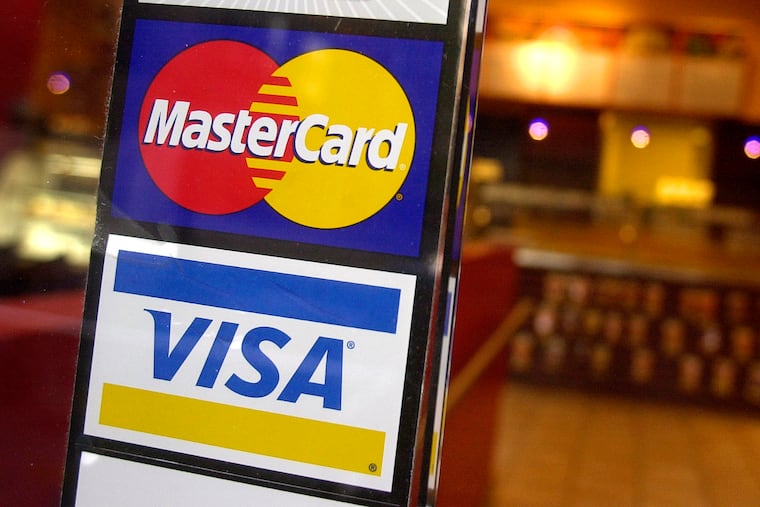 Logos for MasterCard and Visa credit cards are displayed at the entrance of a coffee shop. Legislation in Pennsylvania and Delaware seeks to cut "swipe fees" for merchants, but would inconvenience consumers, writes Pat Toomey.