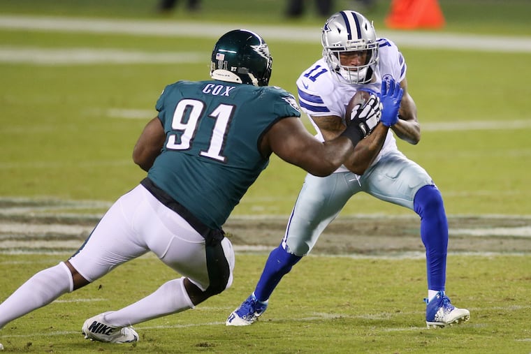Eagles defensive tackle Fletcher Cox (left) prepares to tackle Cowboys wide receiver Cedrick Wilson on Nov. 1. Cox presents financial challenges to the Eagles.