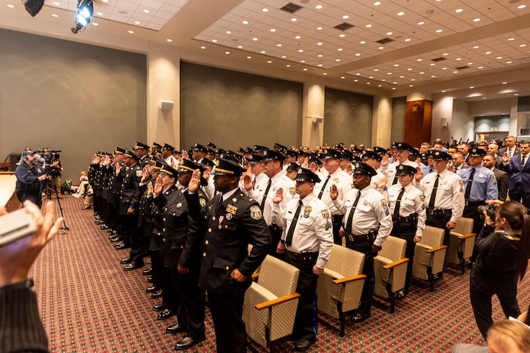 Philadelphia PoliceDepartment officers stand to take an oath as they wait to be promoted at the Pennsylvania Convention Center in November 2023. A promotion for officers of color doesn't guarantee respect, writes Ivy Staten.