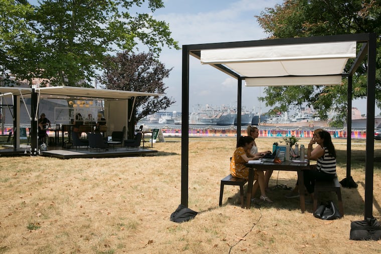 Employees from different companies based at Philadelphia's Navy Yard use the L.L. Bean- and Industrious- sponsored outdoor coworking space on Tuesday morning.