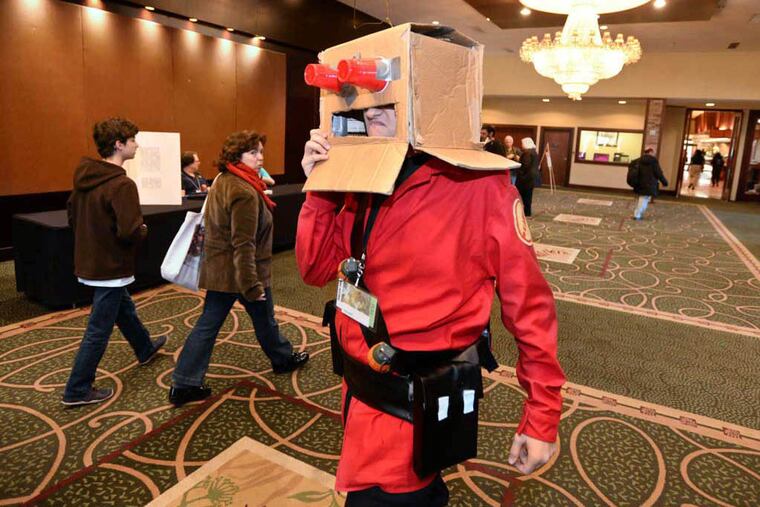 Portraying as a soldier from the video game Team Fortress 2, Joshwah Brewer from North Carolina draws look from a passerby at the Philadelphia Science Fiction Society's annual Philcon, a sci-fi, horror and fantasy convention at the Crown Plaza hotel in Cherry Hill Saturday, November 21, 2014. RON TARVER / Staff Photographer