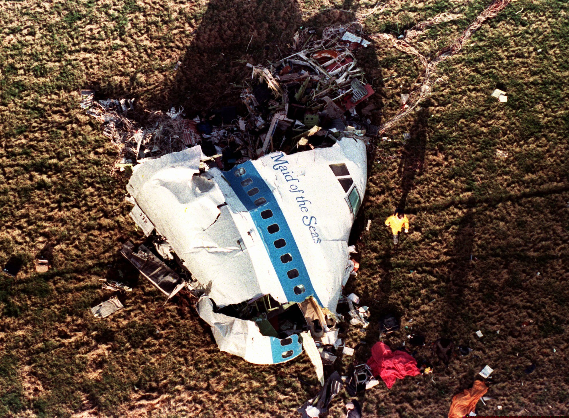 This Dec. 22, 1988 photo shows police and investigators looking at what remained of the nose of Pan Am 103 in a field in Lockerbie, Scotland.