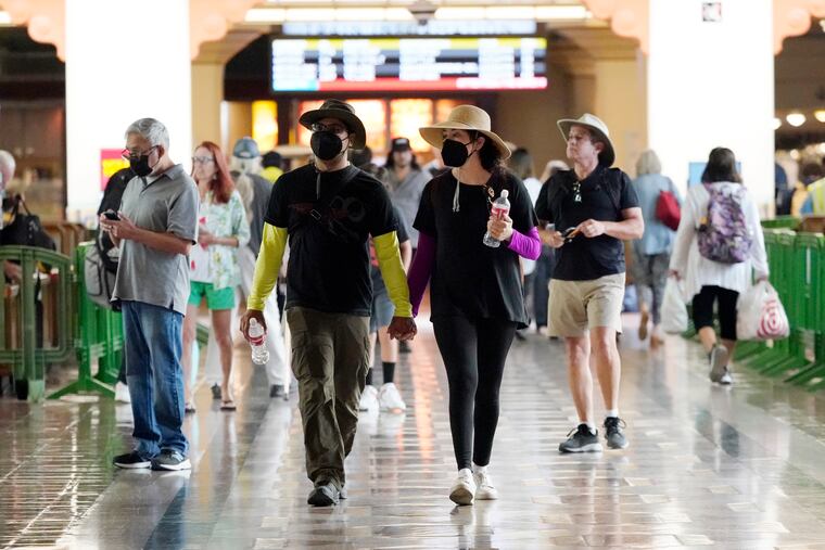 Travelers wear masks inside Union Station Thursday, July 28, in Los Angeles.