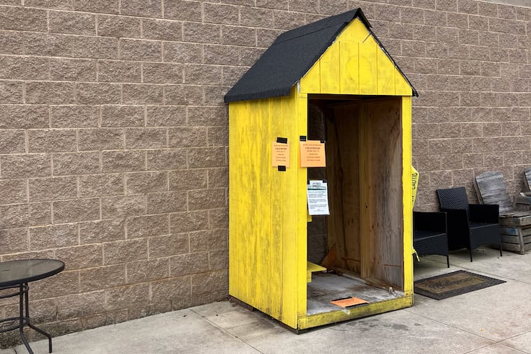 The yellow shelter that once protected the community fridge from the elements sits empty in front of Weavers Way in Ambler.