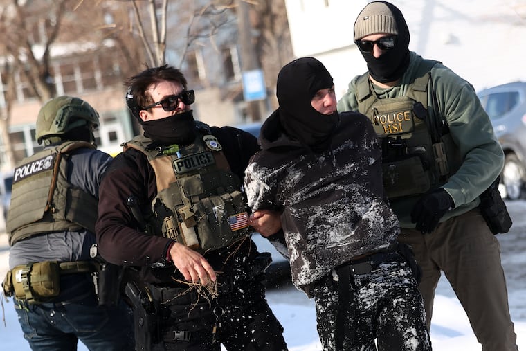 TOPSHOT - Federal agents detain a protester in Minneapolis, Minnesota on February 3, 2026. A US judge on January 31, 2026 denied Minnesota's bid to force Immigration and Customs Enforcement (ICE) to suspend its sweeping detention and deportation operation in the state that has left two US citizens dead and fueled massive protests. Masked and heavily armed federal agents have swept through Minnesota communities seeking undocumented migrants, detaining thousands and shooting dead two US citizens in the process.
